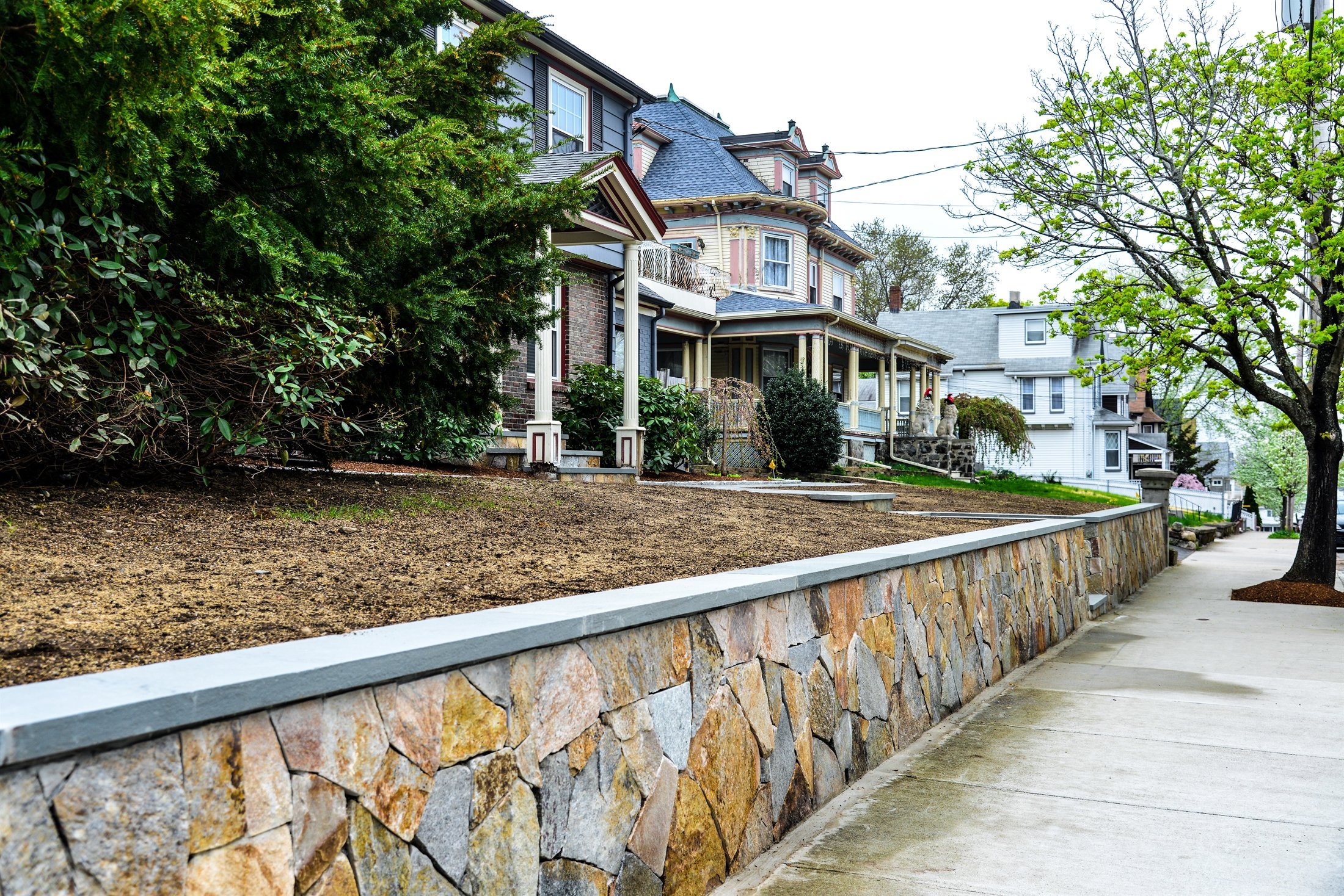 Stone retaining wall showcasing expert masonry craftsmanship