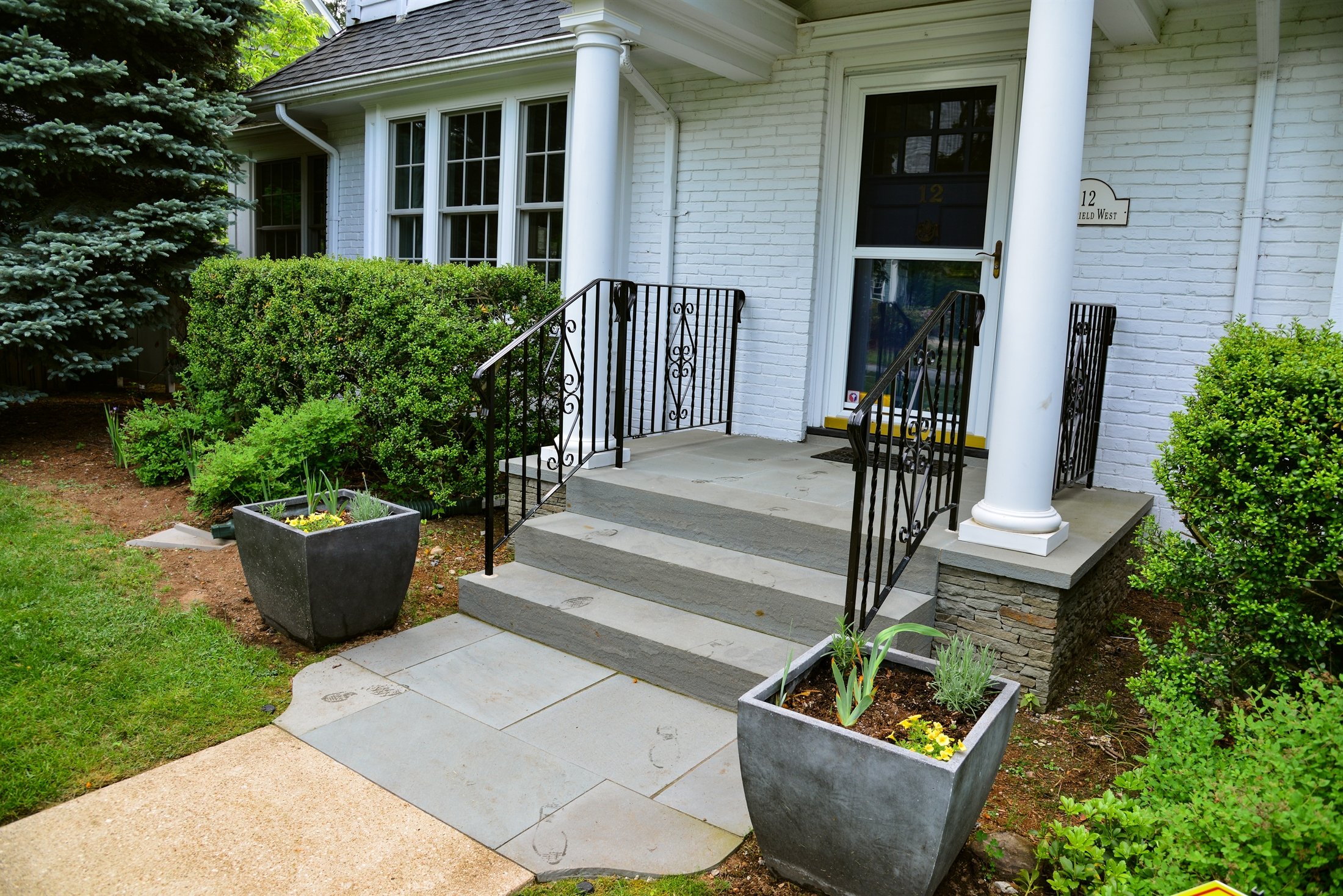 Bluestone front entry steps with wrought iron railings