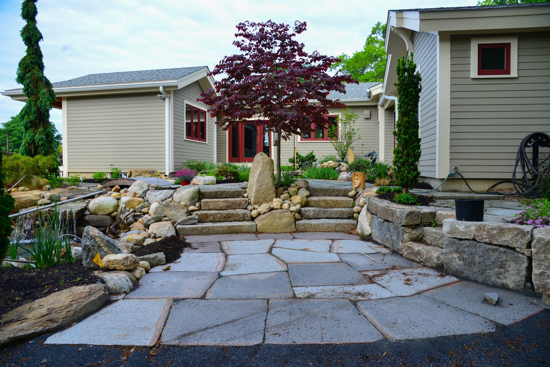 Natural stone staircase with boulder retaining walls